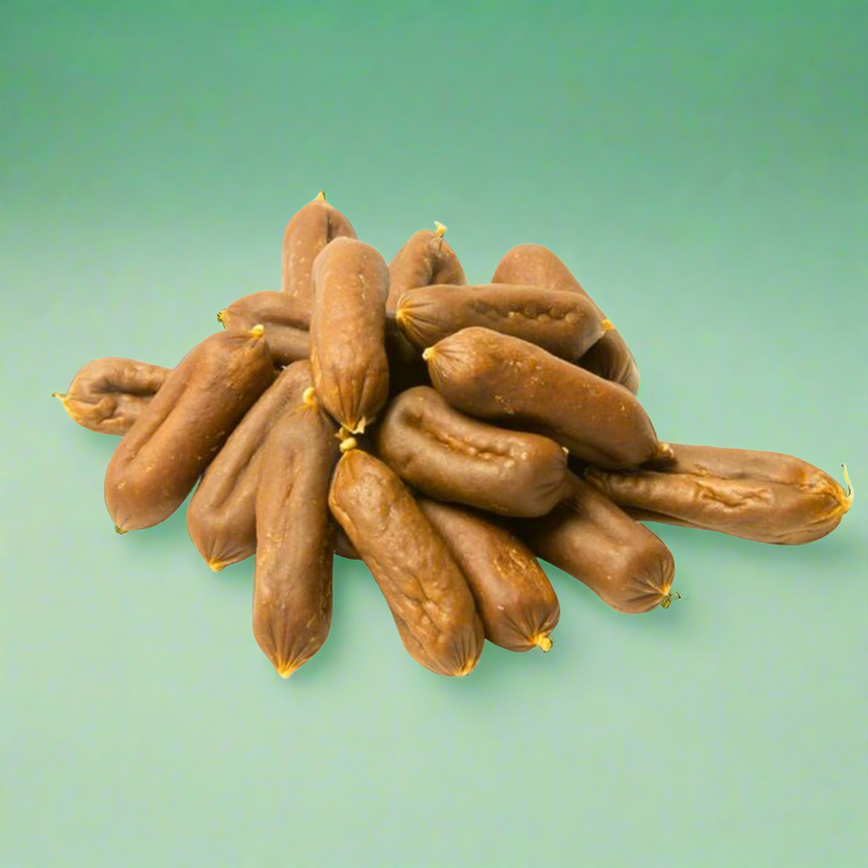 Small beef and garlic sausages for dogs, laid flat