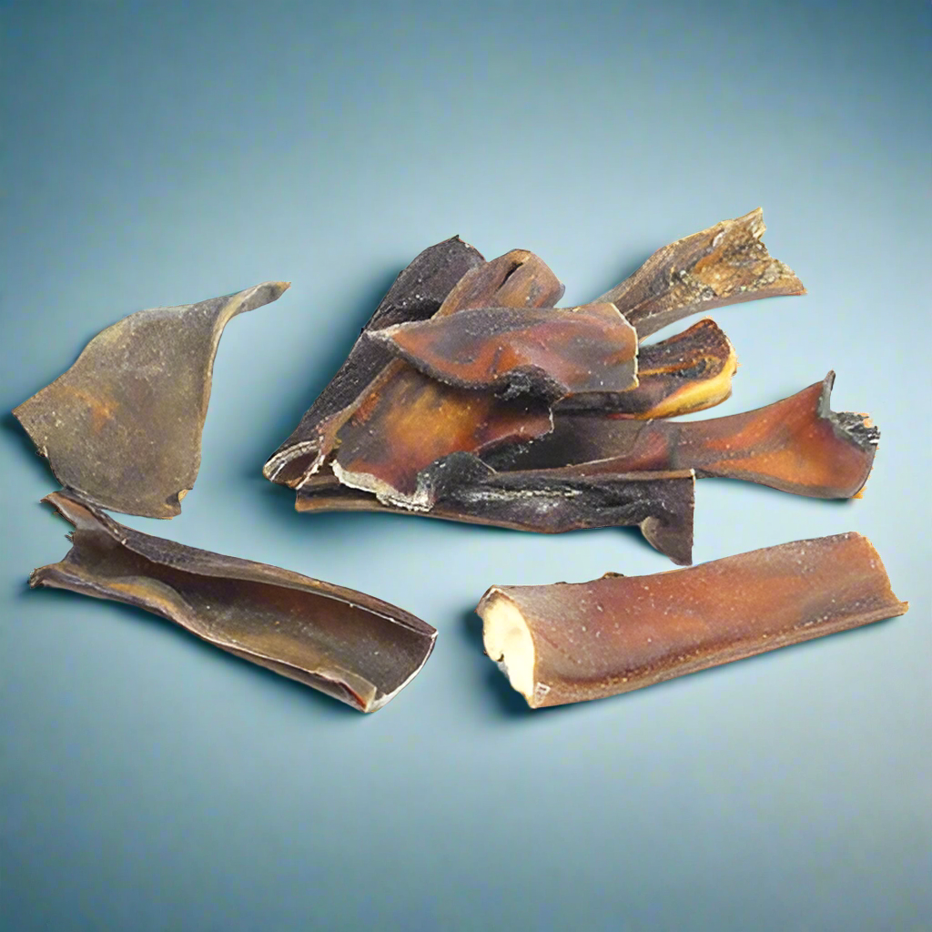 Dark curled pieces of dried buffalo skin, laid flat