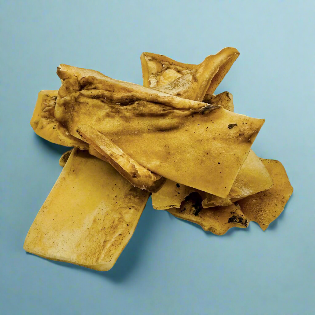 Pale curled pieces of dried beef skin, laid flat