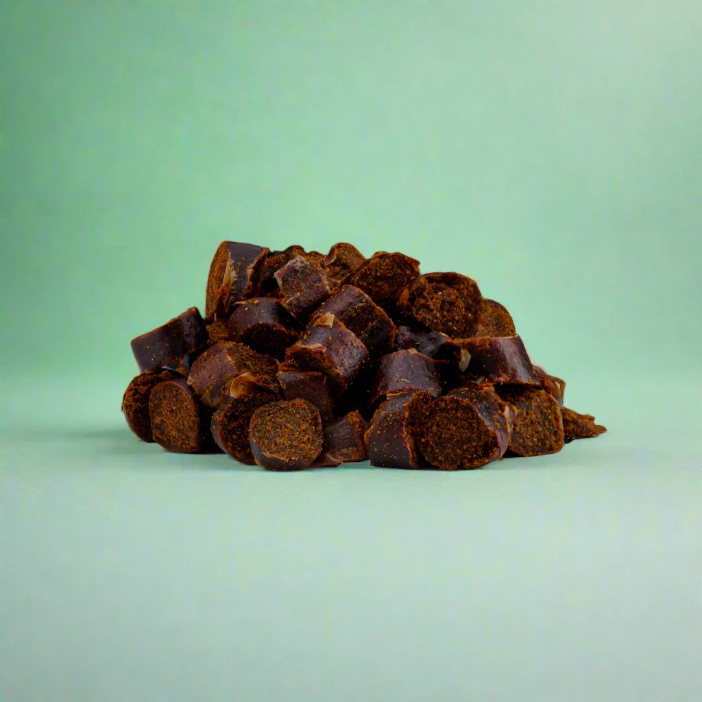 Small black pudding nibbles for dogs, laid flat