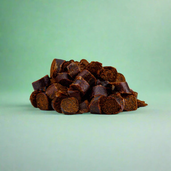 Small black pudding nibbles for dogs, laid flat