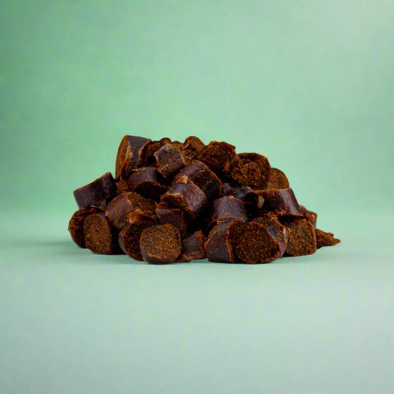 Small black pudding nibbles for dogs, laid flat
