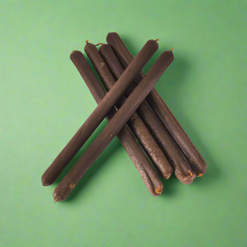 A stack of long beef and vegetables sausages for dogs, laid flat