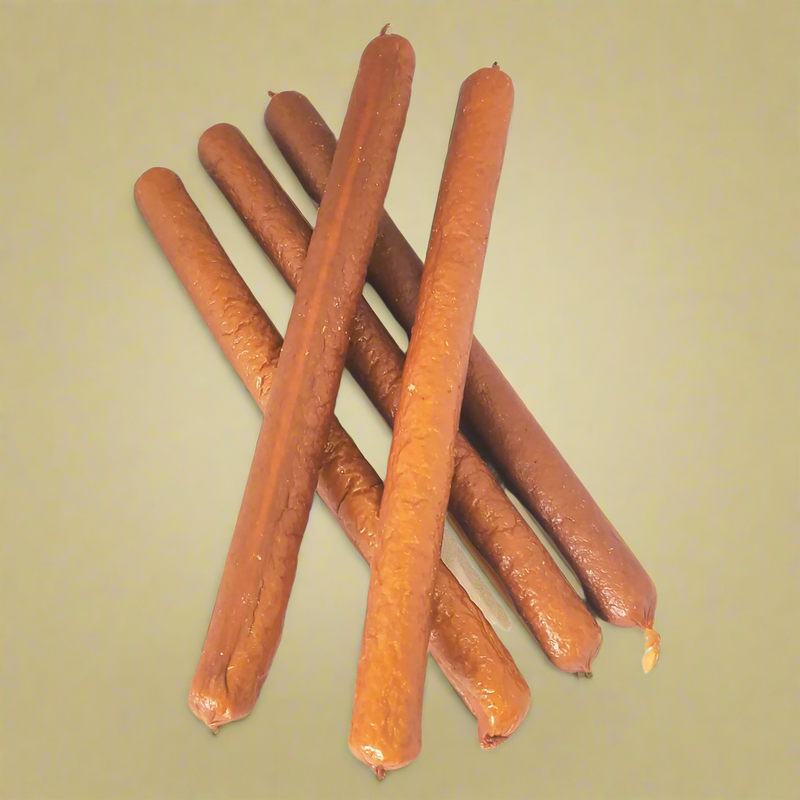 A stack of long chicken sausages for dogs, laid flat
