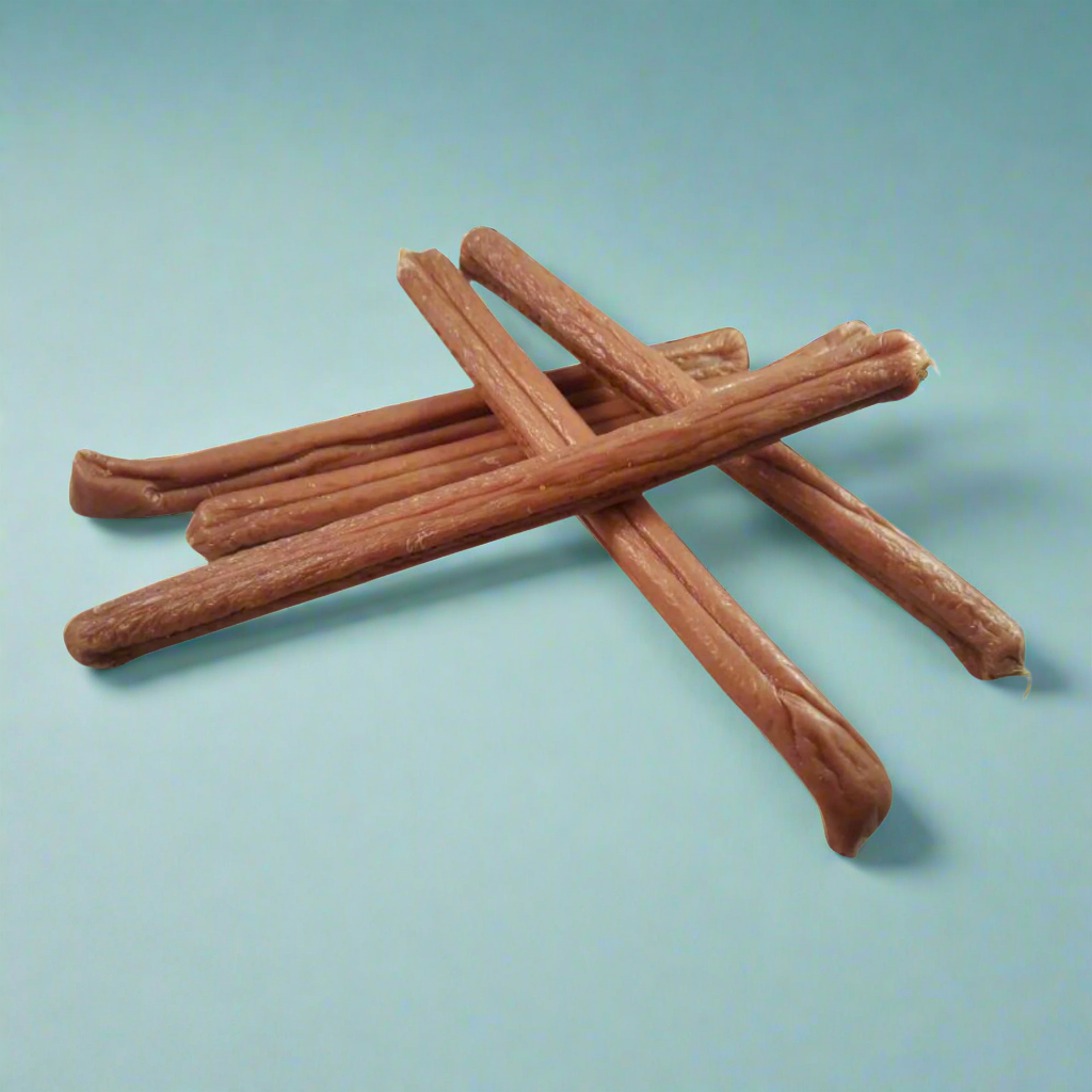 A stack of long chicken and cheese sausages for dogs, laid flat