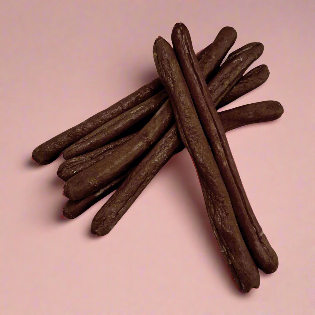 A stack of long duck sausages for dogs, laid flat