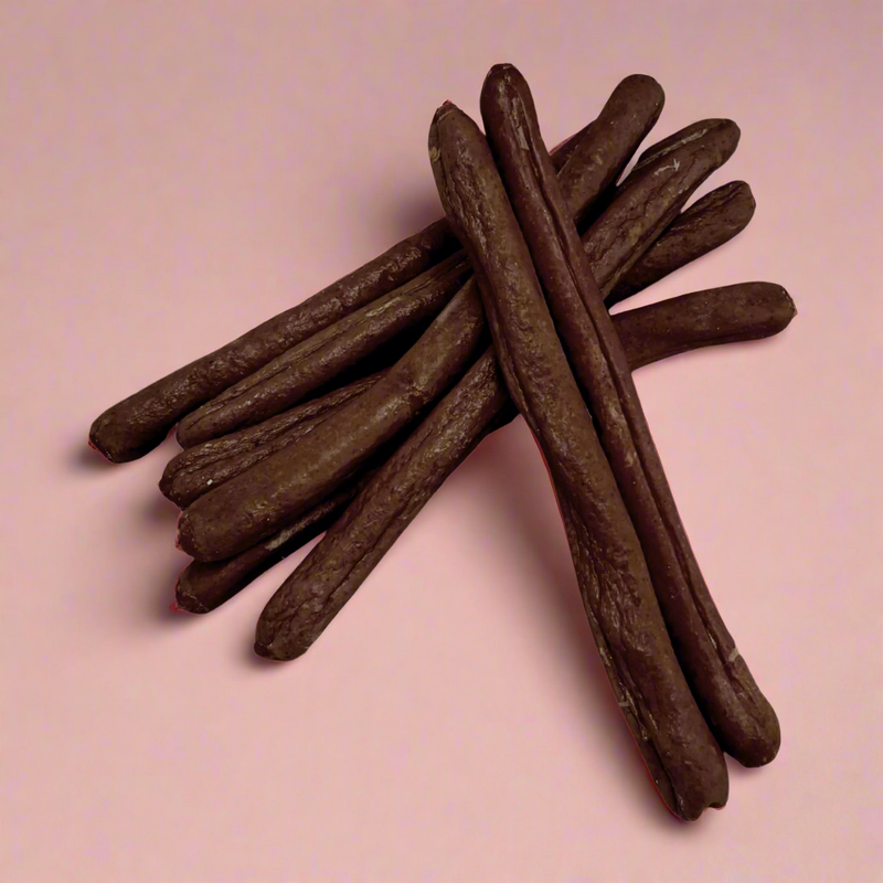 A stack of long duck sausages for dogs, laid flat