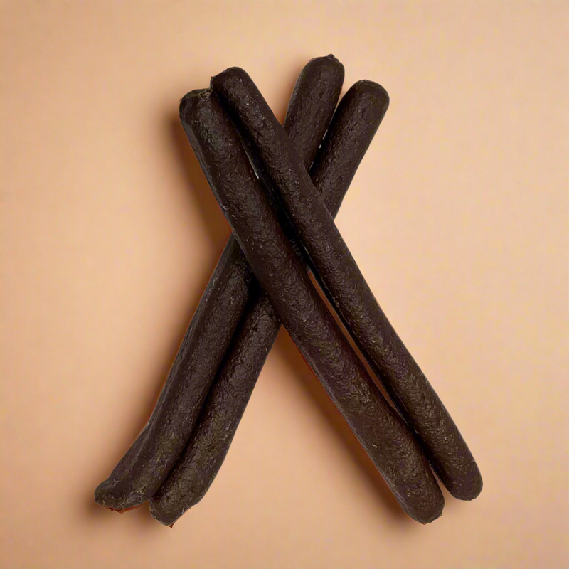 A stack of long beef liver and chicken sausages for dogs, laid flat