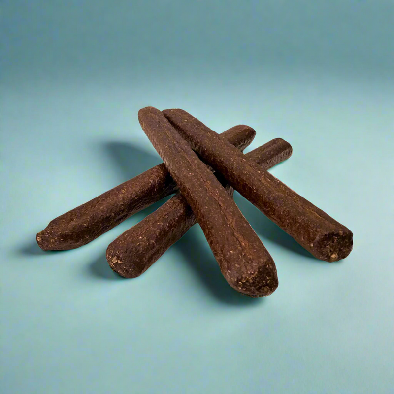 A stack of long beef and cheese sausages for dogs, laid flat