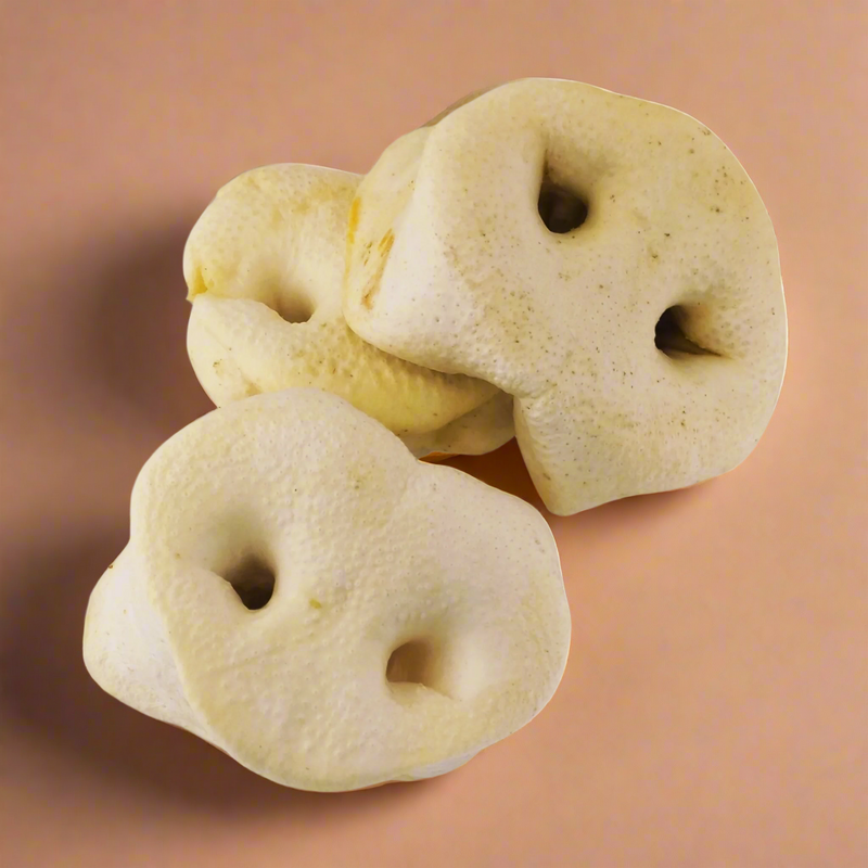 Puffed pig snouts, pale and rounded with two nostril holes, laid flat